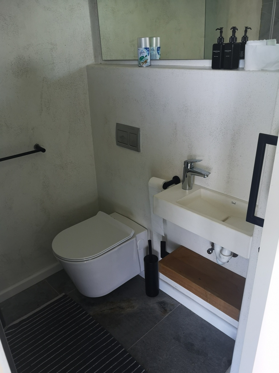 Floating shelf below basin